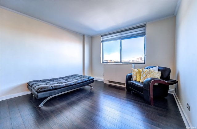 sitting room with dark hardwood / wood-style flooring and crown molding