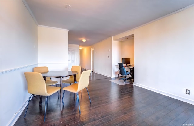 dining room with dark hardwood / wood-style floors and ornamental molding