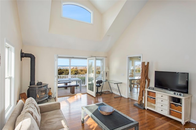 living room featuring a wood stove, french doors, high vaulted ceiling, and dark hardwood / wood-style floors