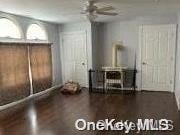 interior space featuring ceiling fan and dark wood-type flooring