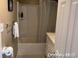 bathroom featuring vanity and shower / bath combo with shower curtain