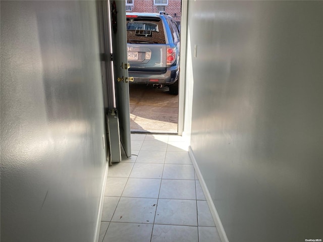 corridor featuring light tile patterned floors