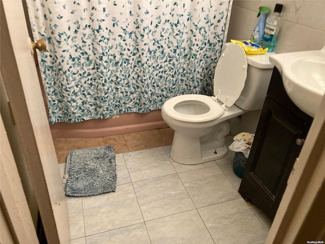 bathroom featuring tile patterned flooring, vanity, and toilet