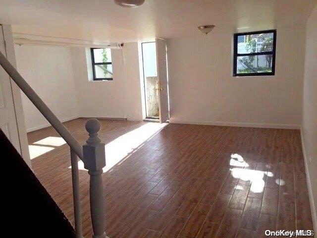 spare room with dark wood-type flooring