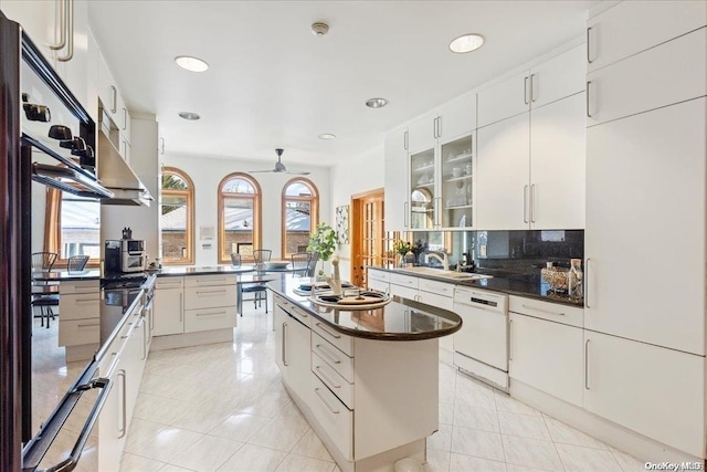 kitchen featuring white cabinetry, dishwasher, a center island, and ceiling fan