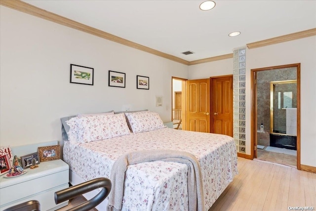 bedroom with ensuite bathroom, light wood-type flooring, and crown molding