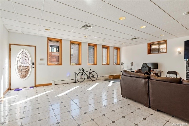 living room featuring a paneled ceiling and a baseboard heating unit