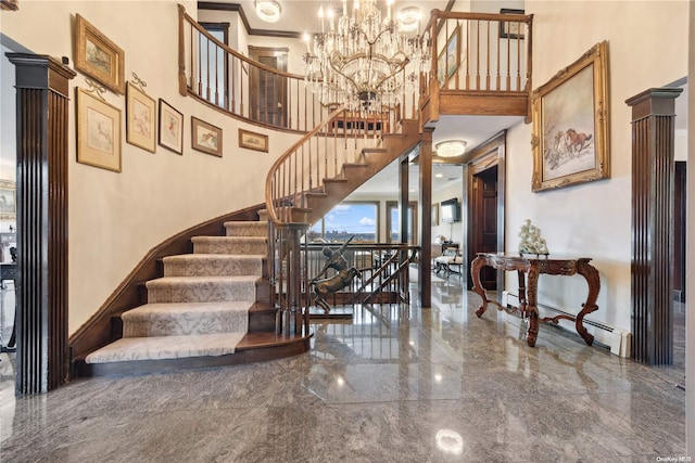 stairs with a towering ceiling, a baseboard radiator, and an inviting chandelier