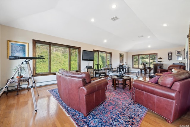 living room featuring wood-type flooring and vaulted ceiling