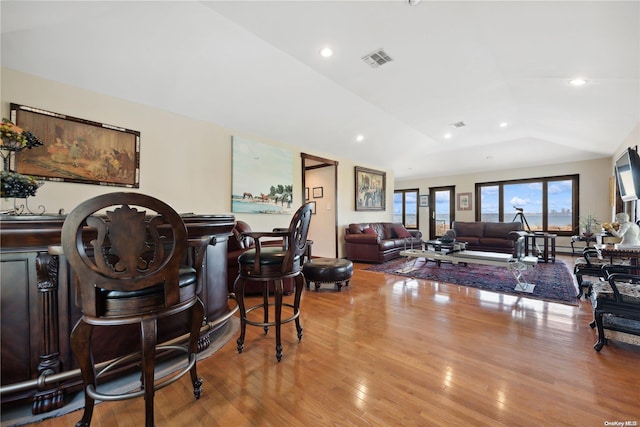 interior space with light hardwood / wood-style floors and lofted ceiling