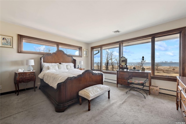 bedroom with light carpet and a baseboard radiator