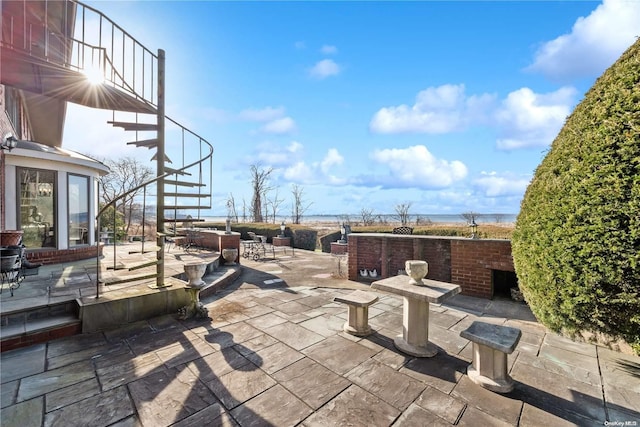 view of patio with a water view