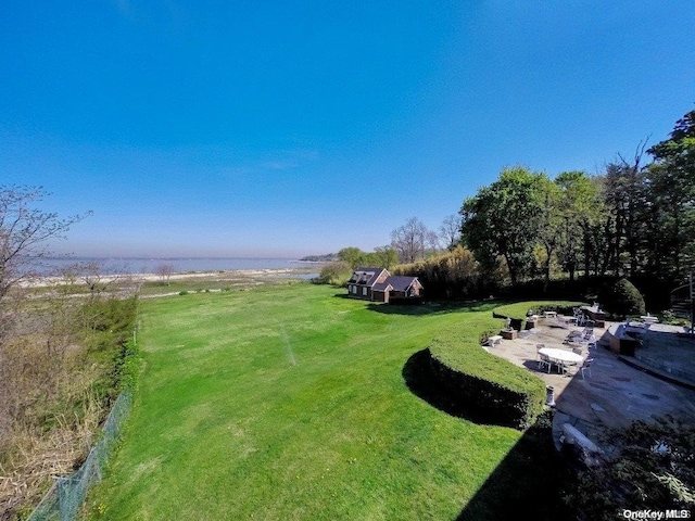 surrounding community with a lawn and a patio area