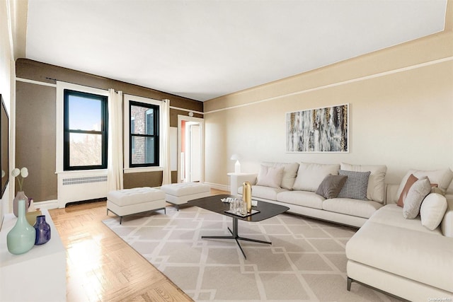 living room with radiator and light parquet flooring