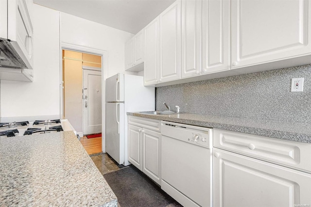 kitchen featuring white cabinets, decorative backsplash, white appliances, and sink