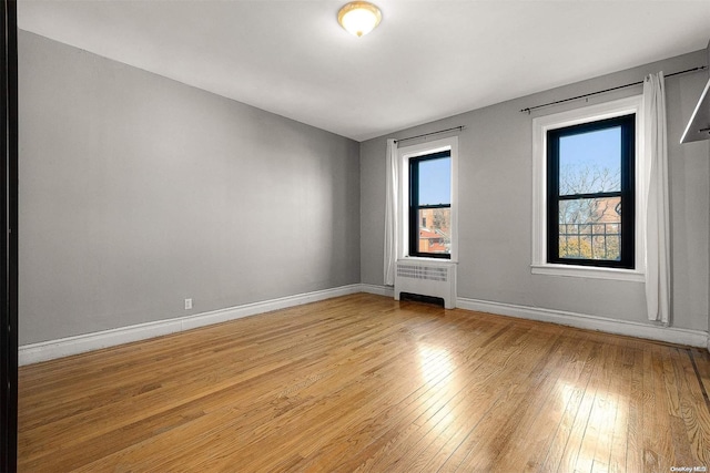 empty room featuring light hardwood / wood-style flooring and radiator