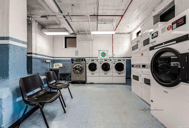 washroom with stacked washer / drying machine and independent washer and dryer