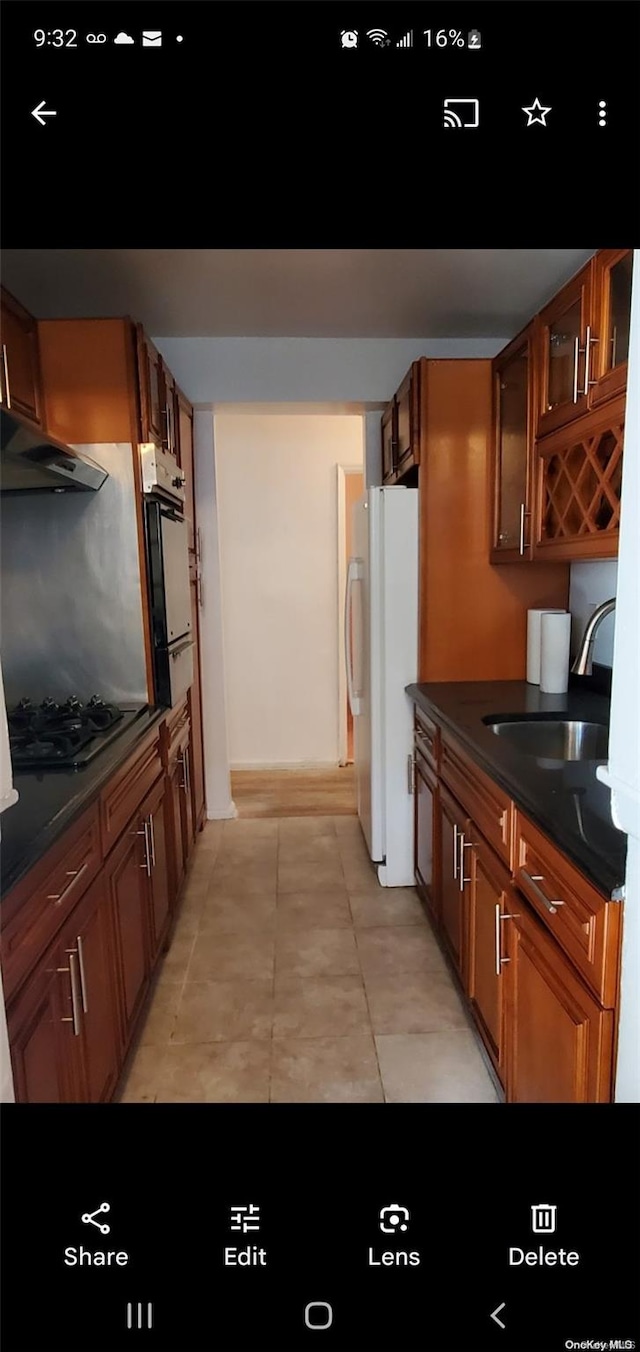 kitchen featuring white appliances and sink