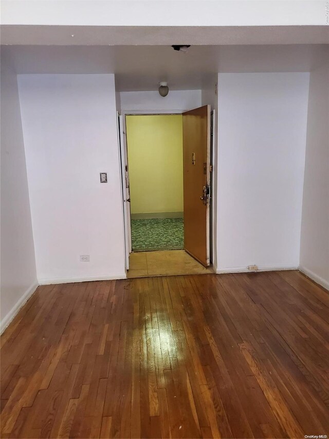 spare room with hardwood / wood-style floors