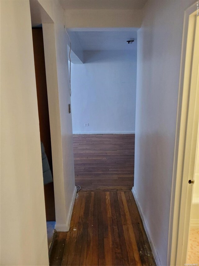 hall with dark wood-type flooring