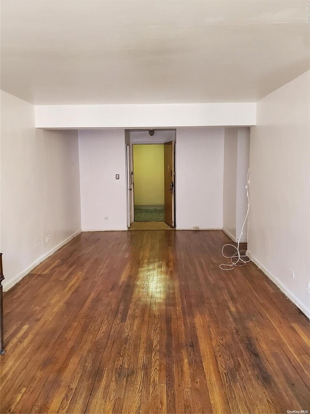 unfurnished room featuring dark hardwood / wood-style floors