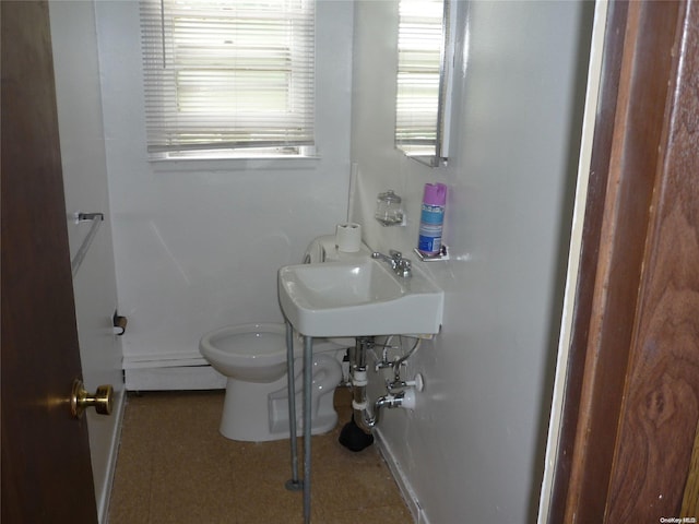 1449 Grand Ave, North Baldwin, NY 11510 - bathroom featuring baseboard heating, sink, and toilet