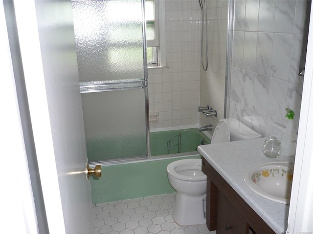 1449 Grand Ave, North Baldwin, NY 11510 - full bathroom featuring shower / bath combination with glass door, tile patterned floors, vanity, and toilet