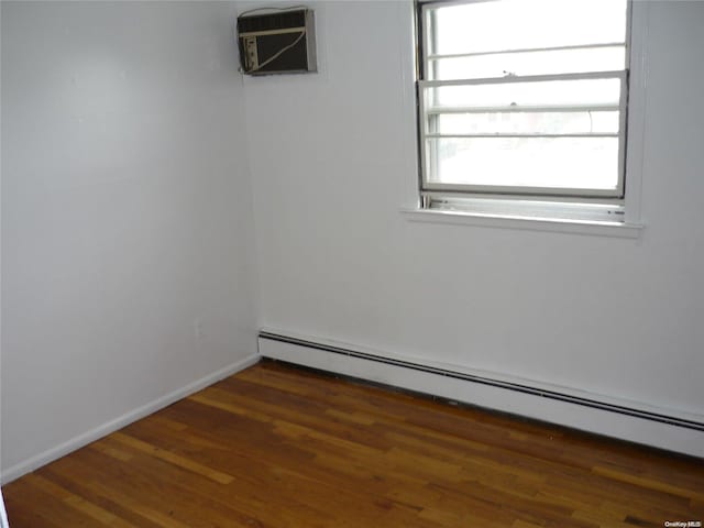 1449 Grand Ave, North Baldwin, NY 11510 - unfurnished room featuring dark hardwood / wood-style flooring, a wall mounted AC, and a baseboard heating unit