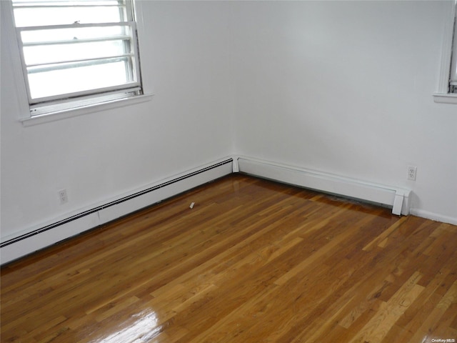 1449 Grand Ave, North Baldwin, NY 11510 - unfurnished room featuring dark hardwood / wood-style flooring and a baseboard heating unit