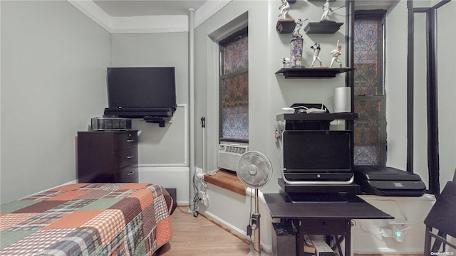 bedroom with crown molding, cooling unit, and hardwood / wood-style flooring