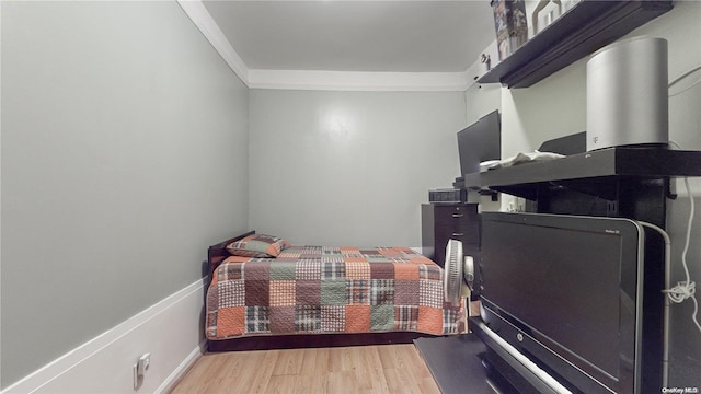 bedroom featuring hardwood / wood-style floors and ornamental molding