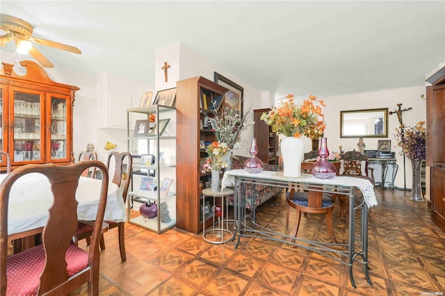 dining area with parquet flooring and ceiling fan