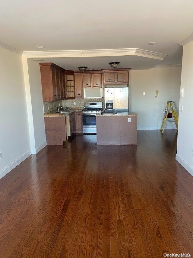 kitchen with gas stove, dark hardwood / wood-style flooring, white fridge with ice dispenser, and ornamental molding