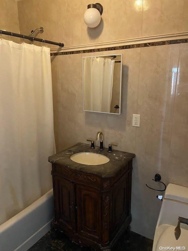 full bathroom featuring vanity, toilet, tile walls, and shower / tub combo with curtain