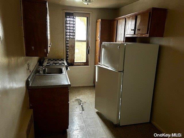 kitchen with white fridge and sink