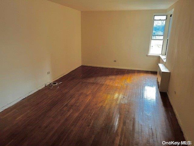 spare room featuring dark hardwood / wood-style floors