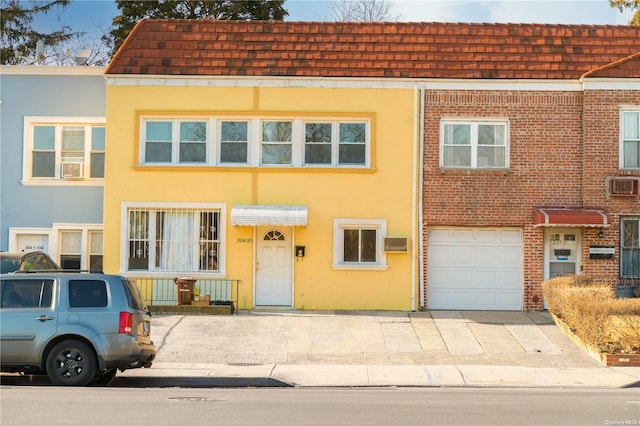 multi unit property with a wall mounted AC and a garage