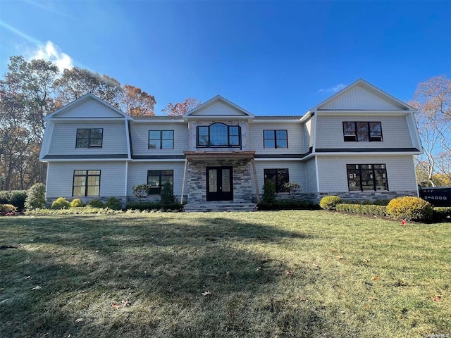 view of front of house featuring a front yard and french doors