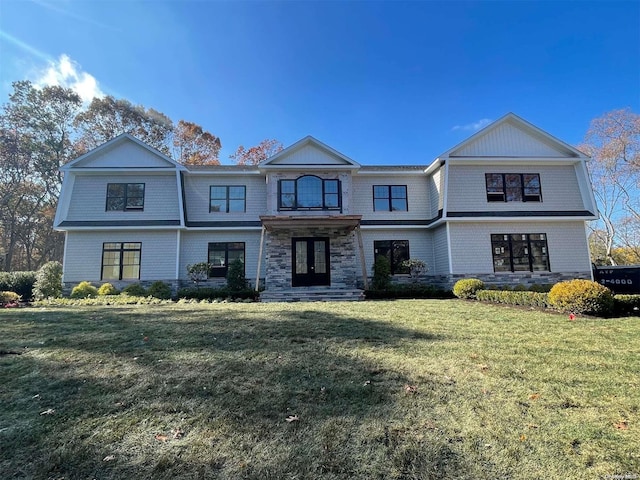 view of front of property featuring a front yard and french doors