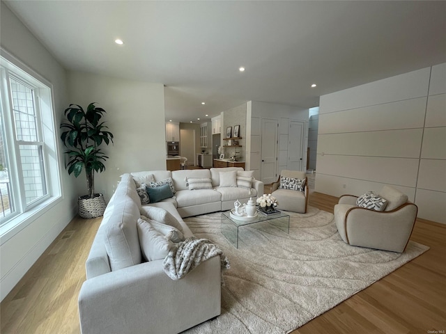 living room featuring light wood finished floors and recessed lighting