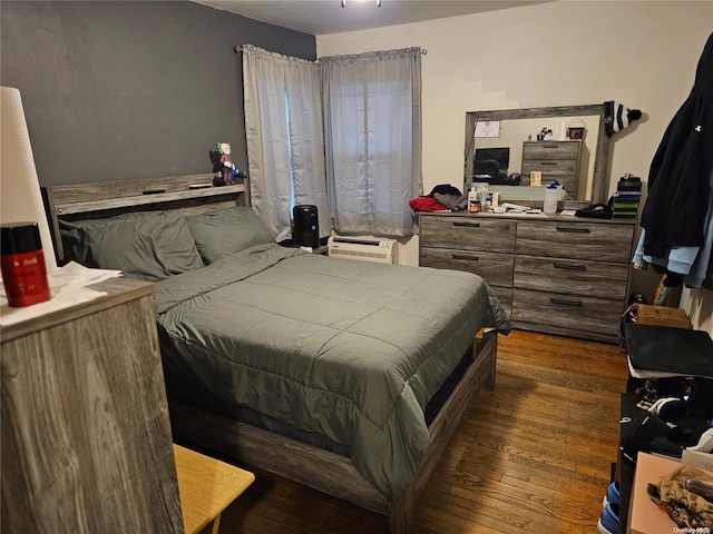 bedroom with dark wood finished floors