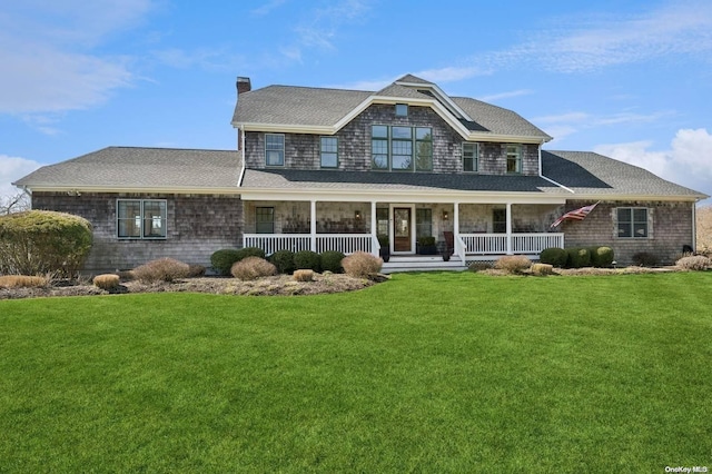 view of front facade with covered porch and a front lawn