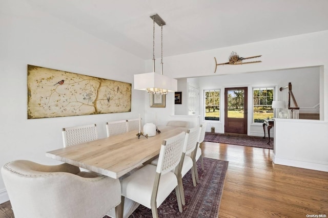 dining area featuring hardwood / wood-style floors and a notable chandelier