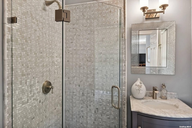 bathroom featuring vanity and a shower with shower door