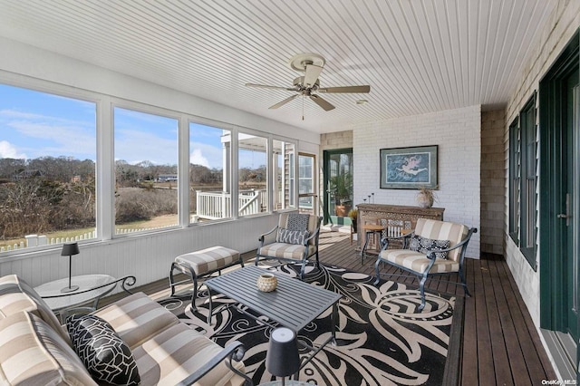 sunroom / solarium with ceiling fan and a healthy amount of sunlight