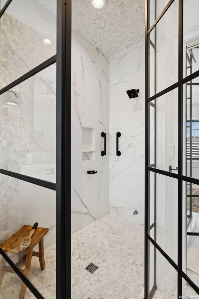 bathroom featuring a tile shower and tile walls