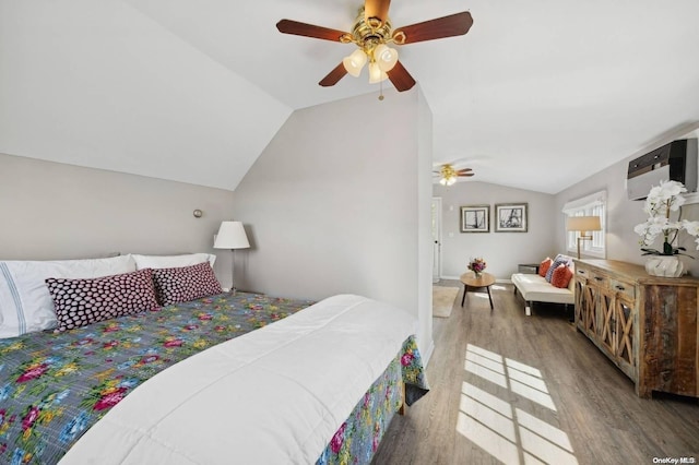 bedroom with a wall mounted AC, wood-type flooring, ceiling fan, and lofted ceiling