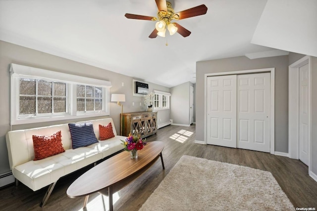 living room with an AC wall unit, ceiling fan, dark hardwood / wood-style flooring, and a baseboard heating unit