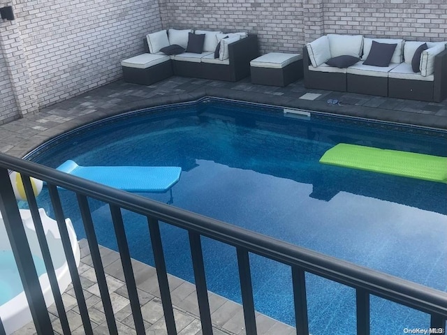 view of swimming pool with an outdoor living space