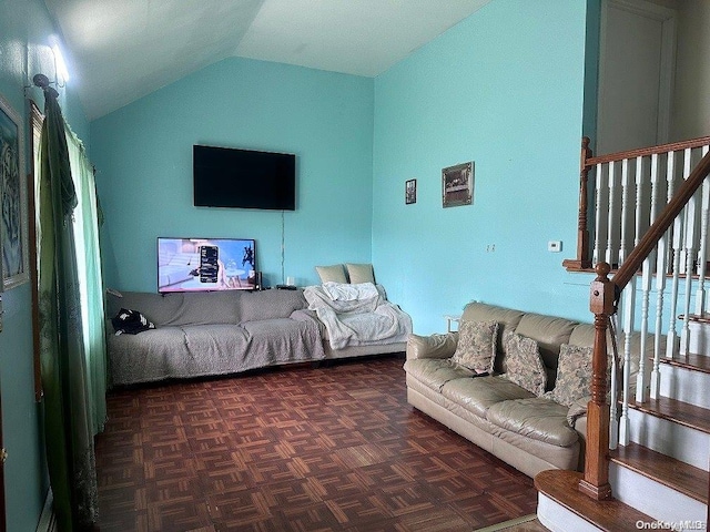 living room featuring dark parquet floors and vaulted ceiling